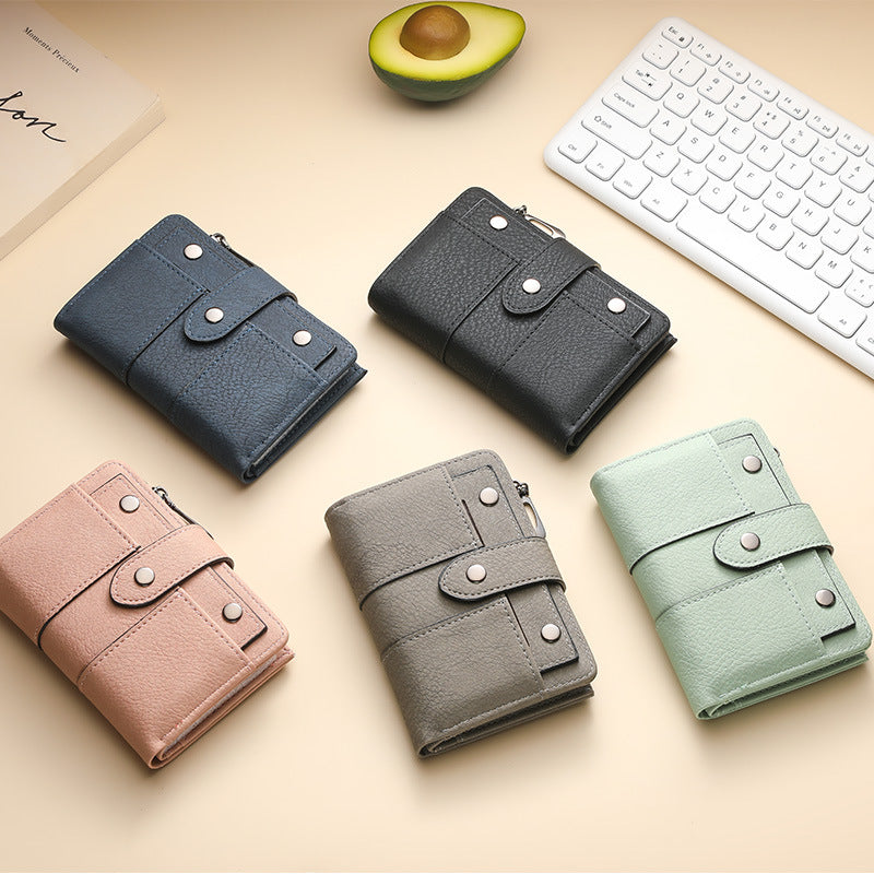 Women's bifold wallets in several colors on a desk