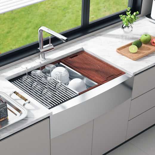 Farmhouse workstation sink with colander accessory in use
