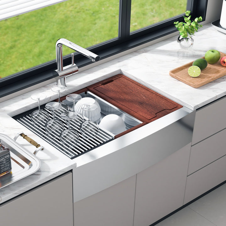 Farmhouse workstation sink with colander accessory in use