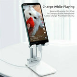 Adjustable phone stand in pink, on desk with phone in landscape