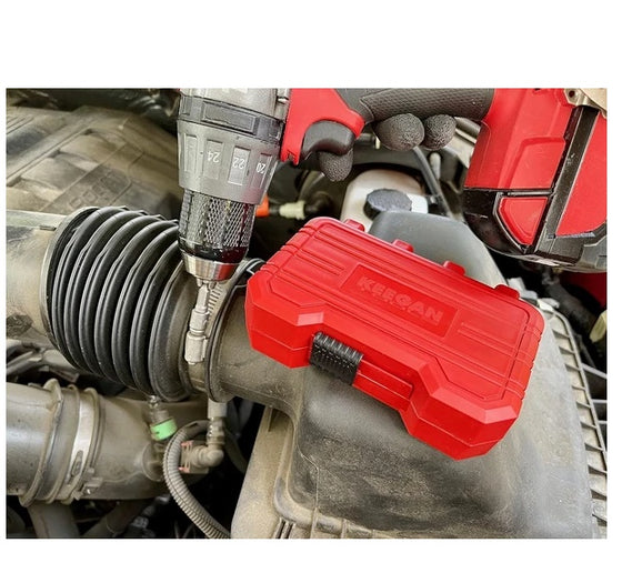 Red bit case resting in a car engine bay