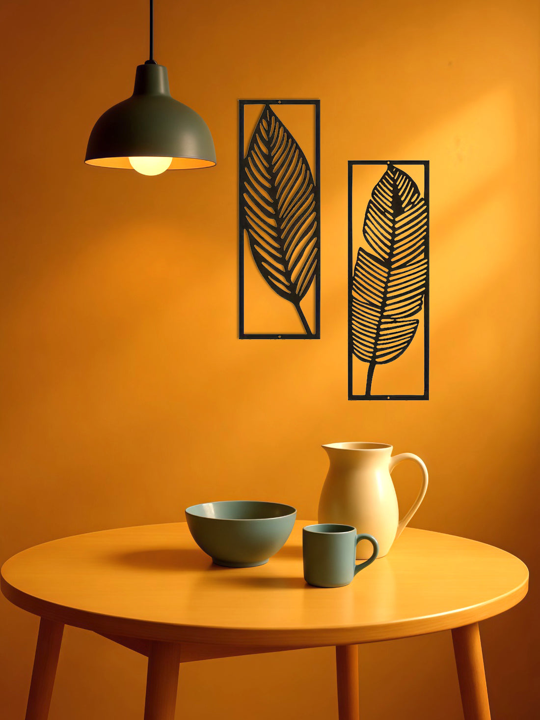 Leaf wall art panels beside a pendant lamp above a table