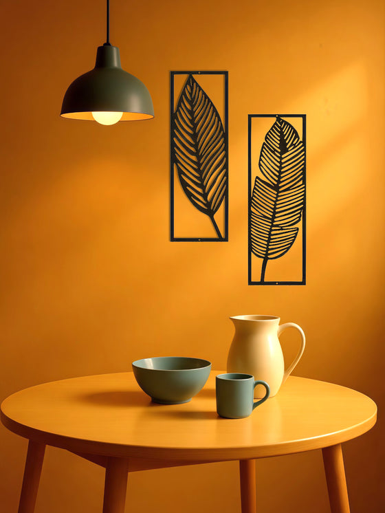 Leaf wall art panels beside a pendant lamp above a table