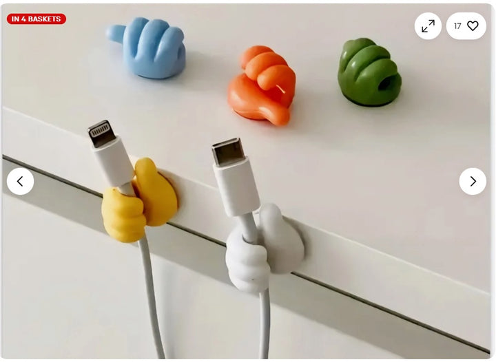Adhesive wall hooks on kitchen wall holding utensils