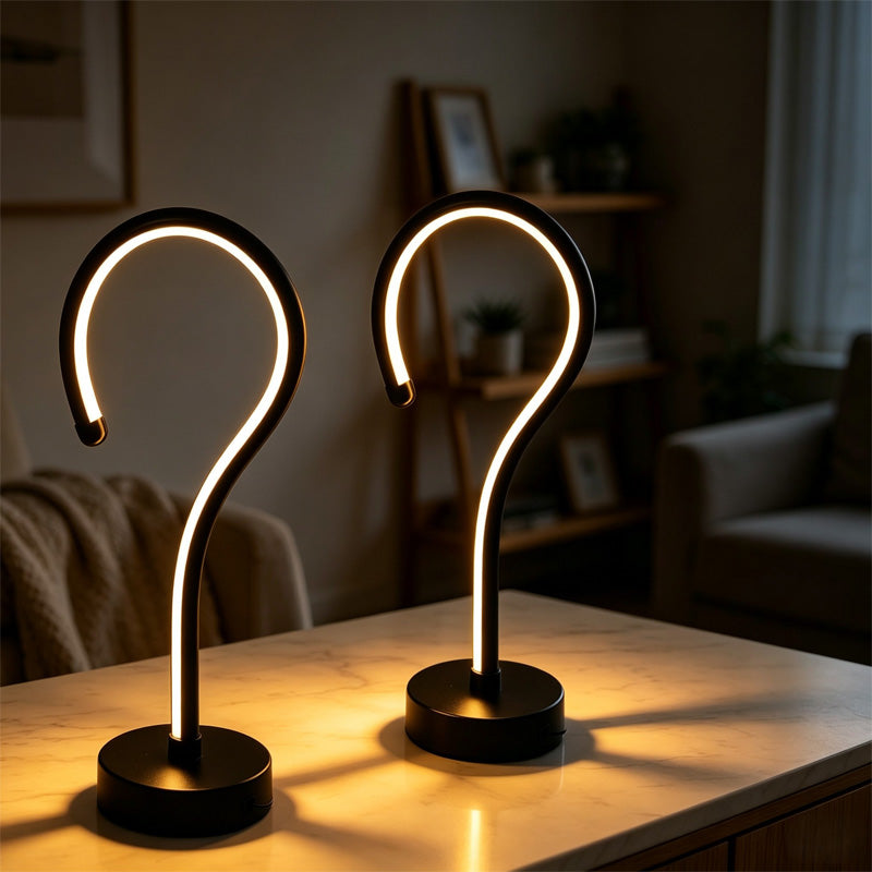 Two question mark LED lamps glowing on a marble table