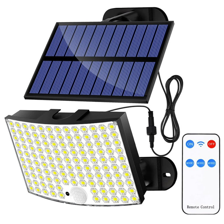 Solar wall light with LED flood beam illuminating driveway