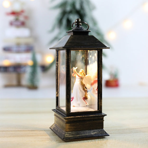 Angel scene Christmas LED flickering flame lantern on a table