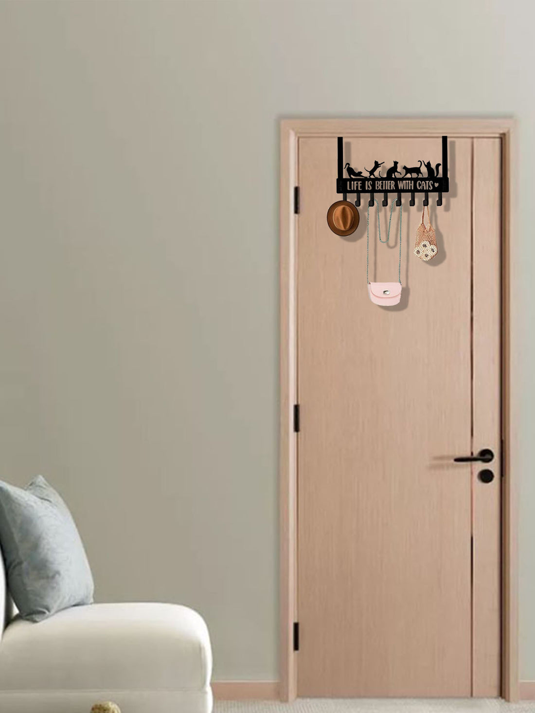Cat hook rack over a light wood door