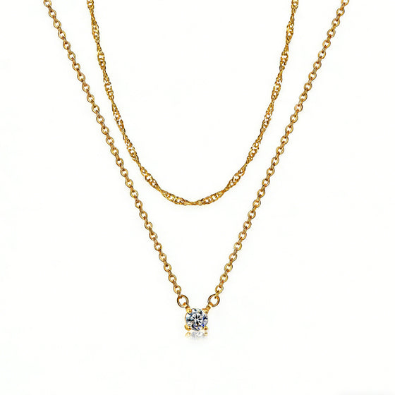 Gold-tone layered necklace set with twisted rope chain and single cubic zirconia pendant