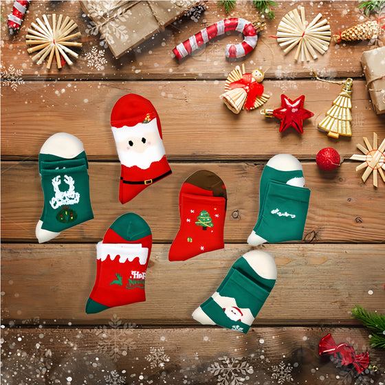 Red and green Christmas socks with Santa, tree and snowman designs on a wooden table