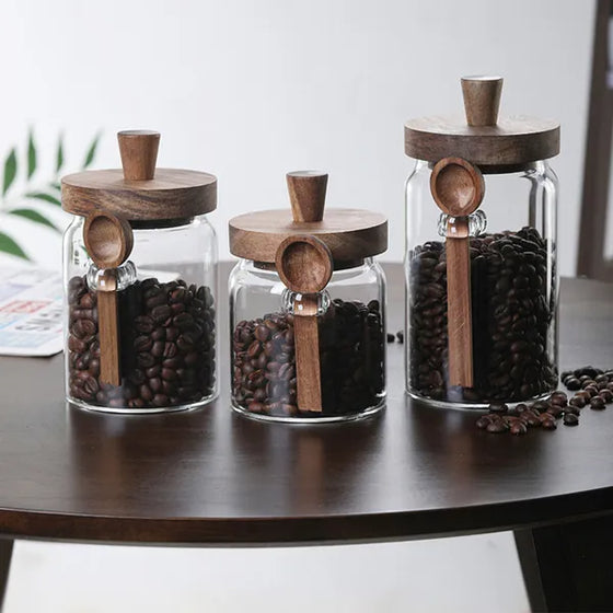 Three coffee jars with spoons on a table