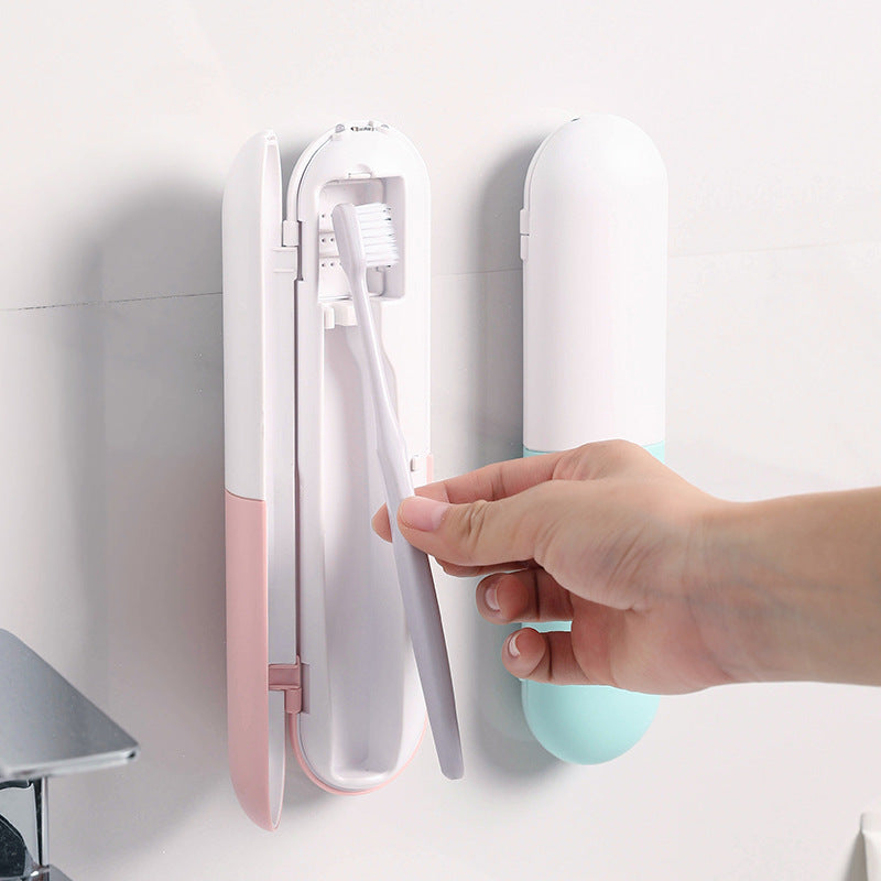 Hand sliding a toothbrush into a slim white wall-mounted toothbrush case