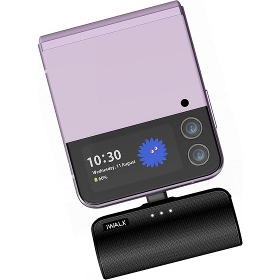 Black mini power bank plugged into a flip phone