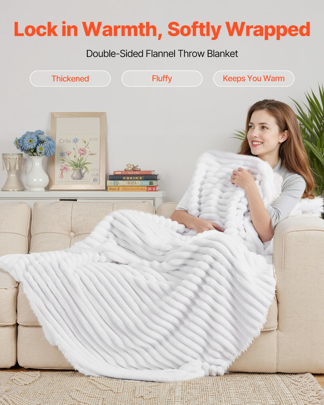 Woman wrapped in a white double-sided flannel throw on a sofa