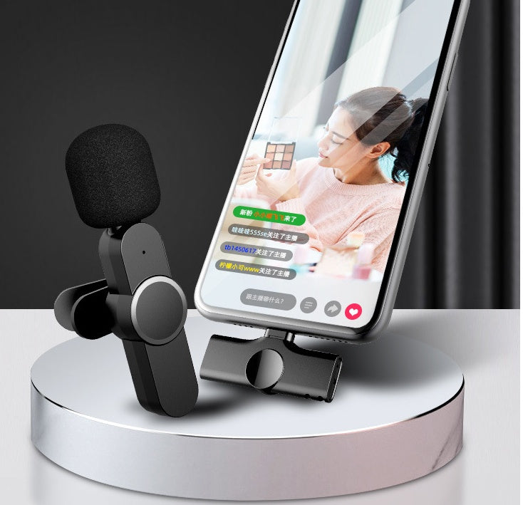 Charging case open showing both mic units docked inside