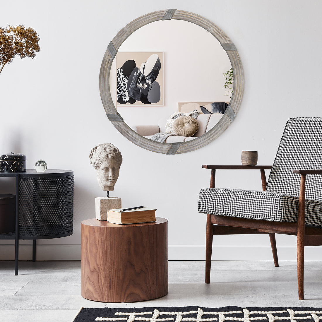 30-inch round wood wall mirror mounted above console