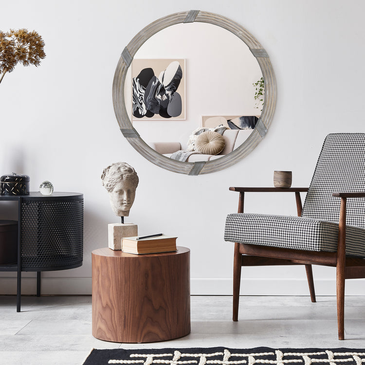 30-inch round wood wall mirror mounted above console