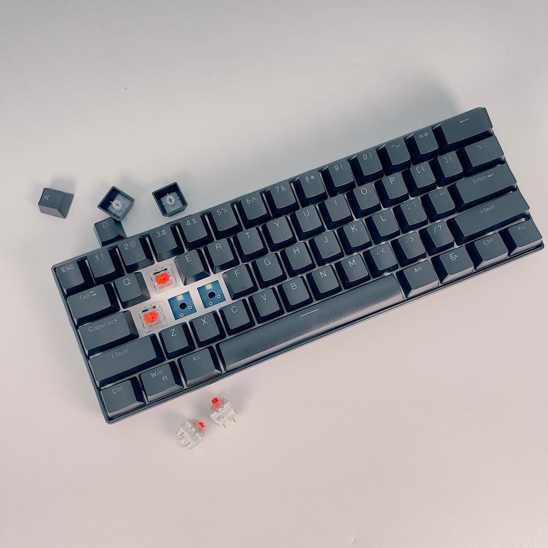 Gray 60% mechanical keyboard with exposed red and blue switches