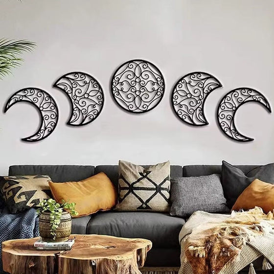 Moon phase wall art above a brown sofa