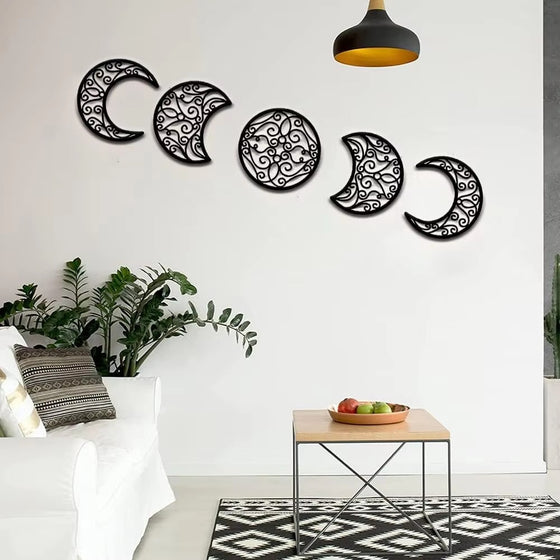 Moon phase wall art in an arc above a sofa