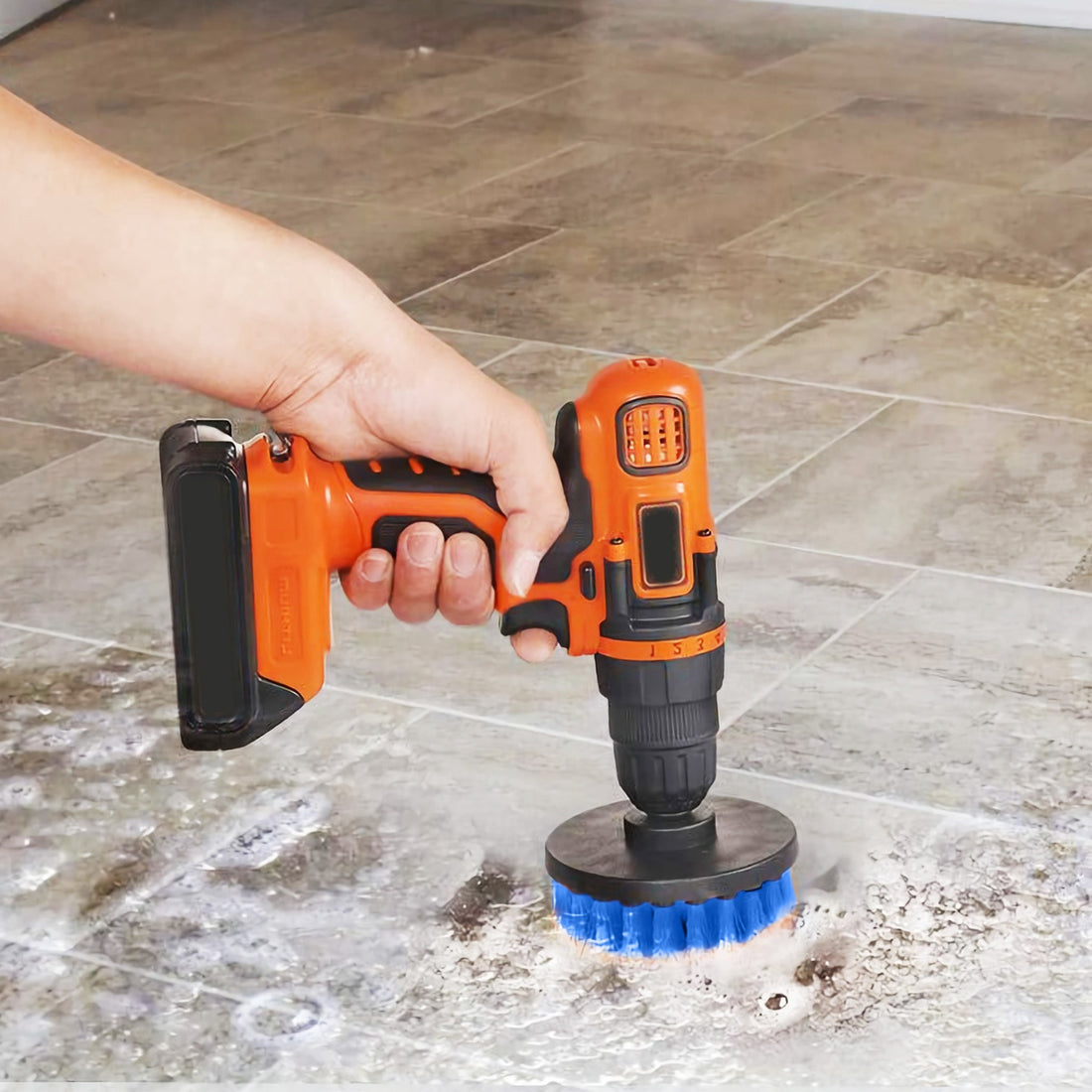 Drill scrubbing a stone floor with a blue brush