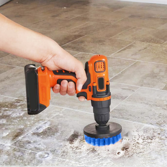 Drill scrubbing a stone floor with a blue brush