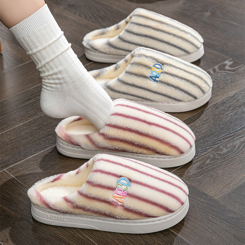 Person in white socks stepping into striped plush slippers