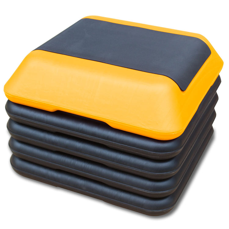 Yellow and black stacked aerobic step platform showing individually adjustable riser blocks