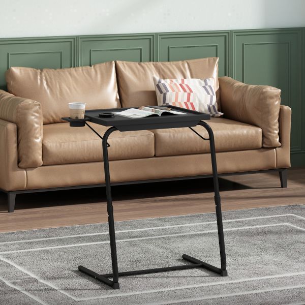 Adjustable TV tray table with a built-in cup holder positioned beside a sofa armrest