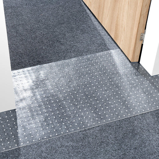 Cat carpet protector mat trimmed to fit a doorway threshold, its textured surface designed to resist claw scratching