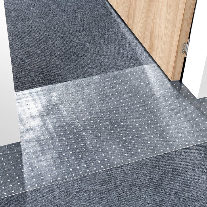 Cat carpet protector mat trimmed to fit a doorway threshold, its textured surface designed to resist claw scratching