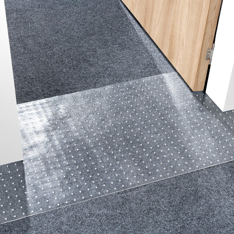 Cat carpet protector mat trimmed to fit a doorway threshold, its textured surface designed to resist claw scratching