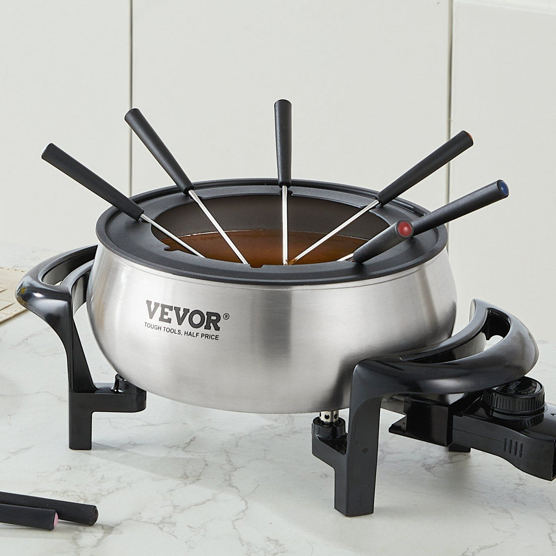 Electric fondue pot set with the 3 quart pot at center surrounded by its 8 included forks