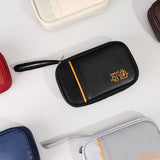Cable organizer pouch opened to show elastic loops and compartments