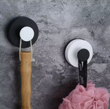 Punch-free vacuum suction cup hook mounted on white bathroom tile