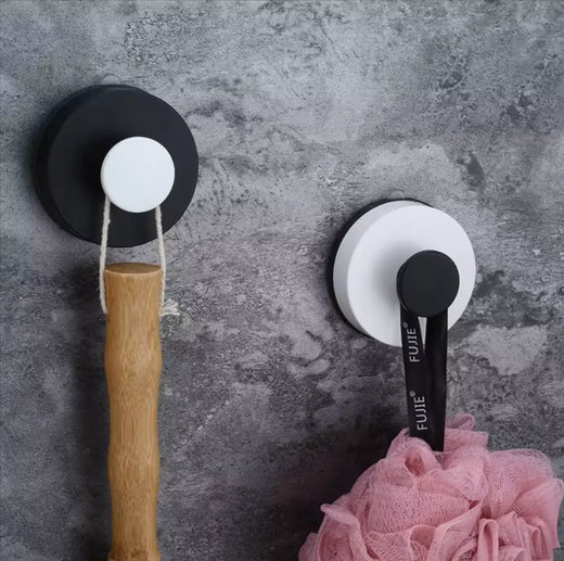 Punch-free vacuum suction cup hook mounted on white bathroom tile