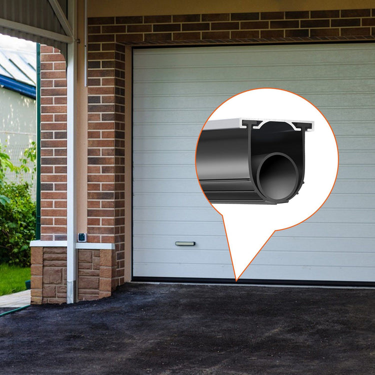 Black rubber tubular door seal fitted into an aluminum track along a white sectional garage door