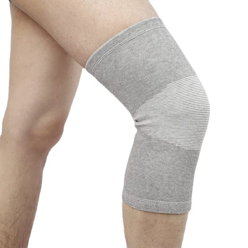 Bamboo knit knee compression sleeve in grey on a runner's leg