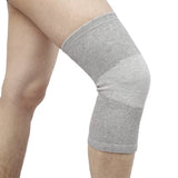 Bamboo knit knee compression sleeve in grey on a runner's leg