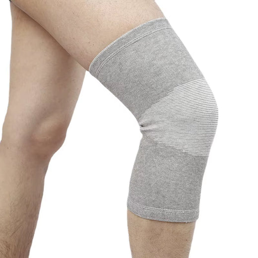 Bamboo knit knee compression sleeve in grey on a runner's leg
