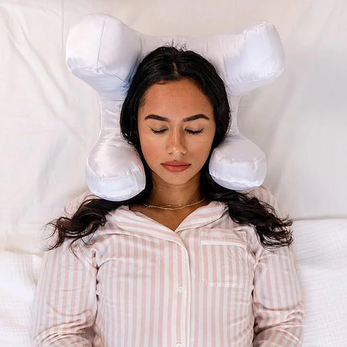 White satin beauty sleep pillow molded into four rounded lobes that cradle the head and ears