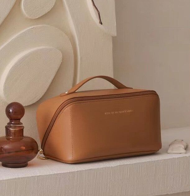 Large leather-style travel makeup bag open showing interior