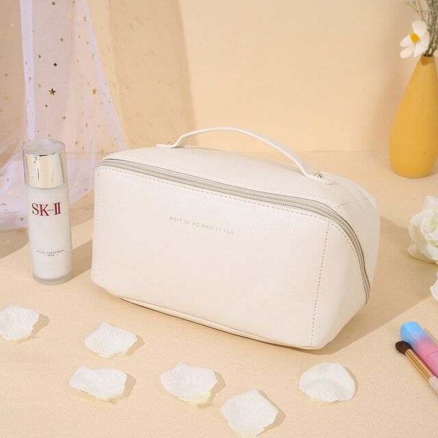 White travel makeup bag styled on bathroom counter