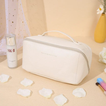 White travel makeup bag styled on bathroom counter