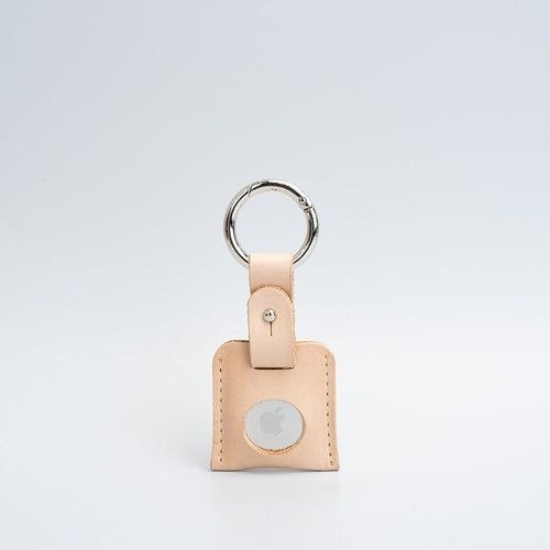 Leather AirTag holder case clipped to a keyring