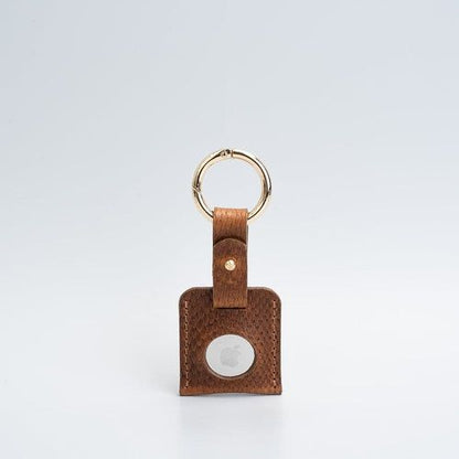 Leather AirTag keychain case showing snug AirTag fit