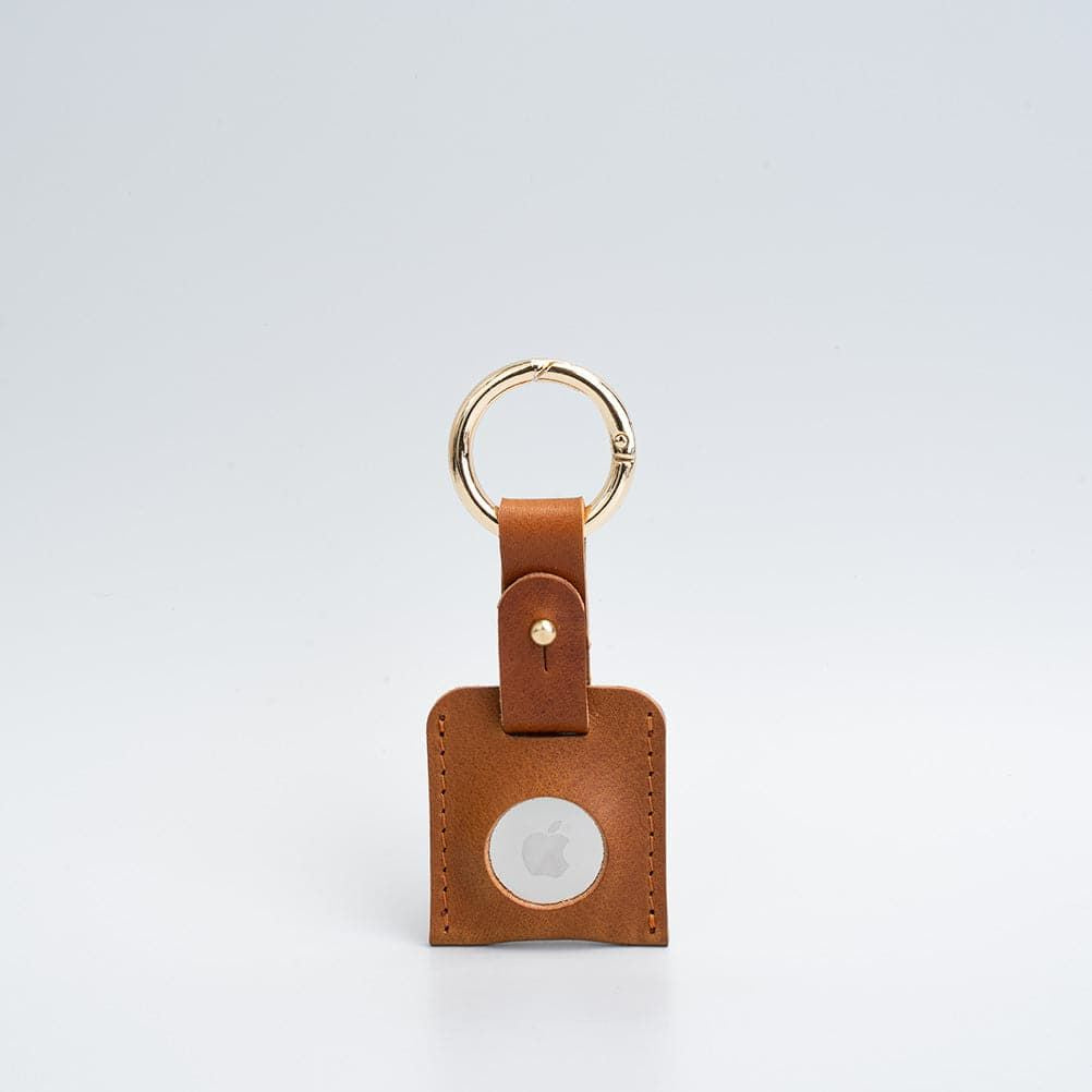 Leather AirTag case attached to bag handle