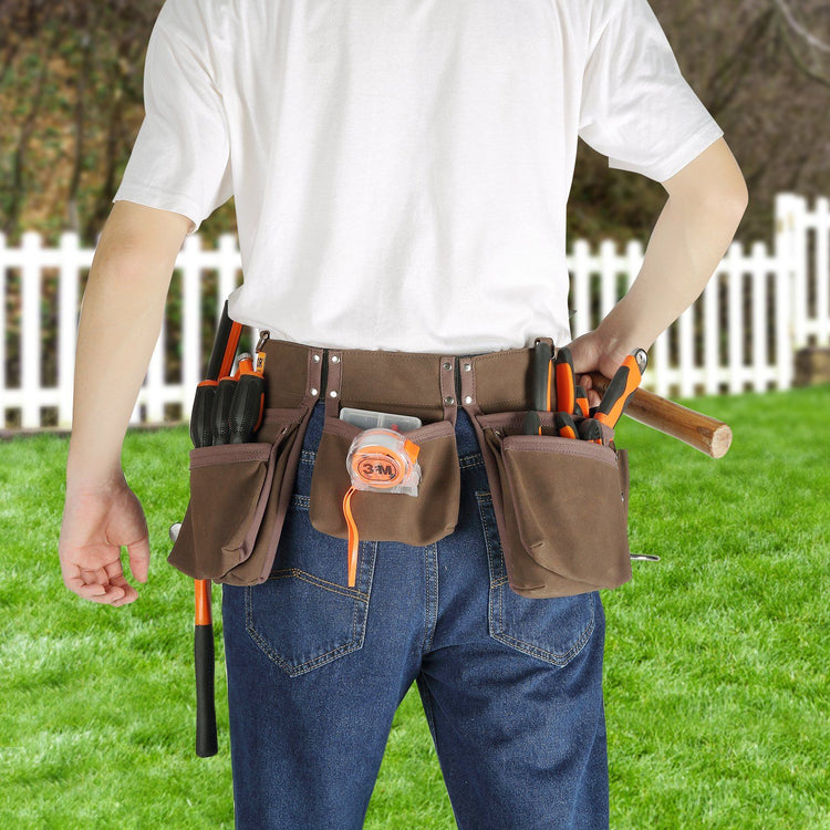 Worker wearing leather tool belt with 13 pockets on job site
