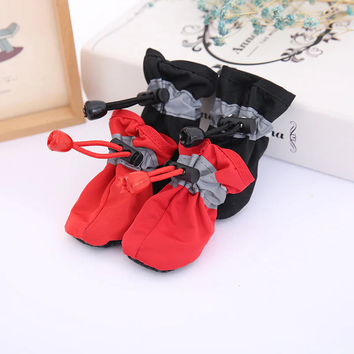 Water-resistant dog boots with reflective grey trim, adjustable drawstring cord-lock closures, and non-slip rubber soles