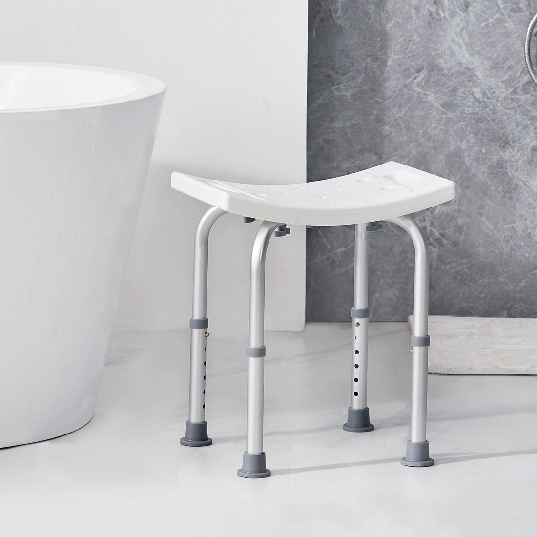 Non-slip adjustable bath stool with side grab handles positioned for stepping in and out of a shower safely